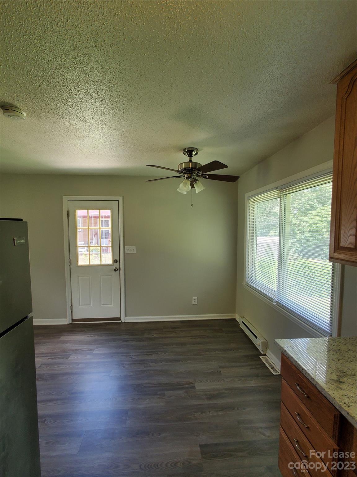 216 Lakeside Avenue Davidson, NC 28036 - Photo 3 of 6 an empty room with wooden floor and windows