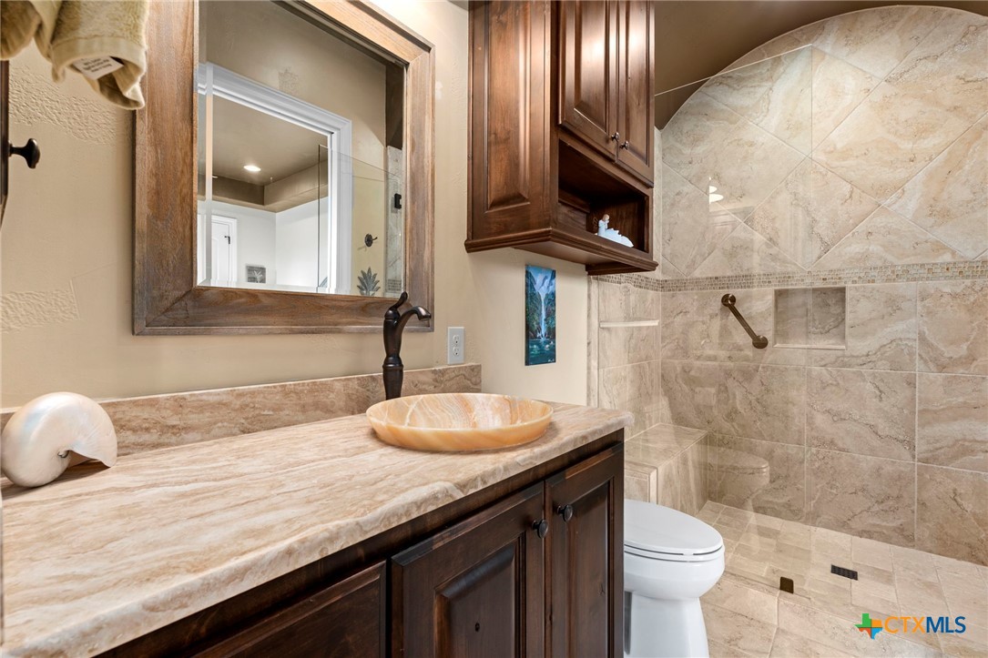 1039 Bluewater Place Spring Branch, TX 78070 - Photo 46 of 48 a bathroom with a granite countertop sink a toilet and bathtub