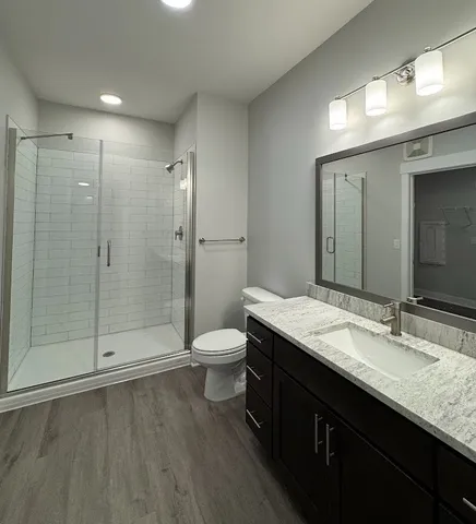 a living room with furniture wooden floor and large windows