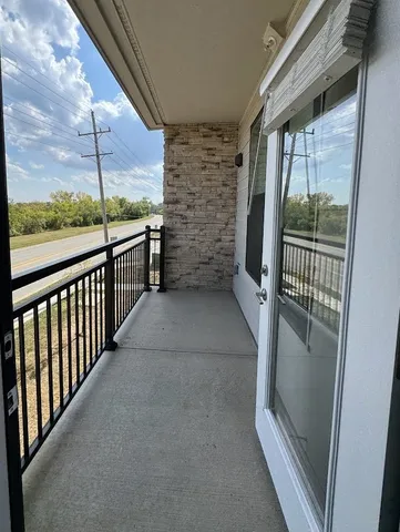 a kitchen with stainless steel appliances kitchen island granite countertop a refrigerator a sink and a stove top oven