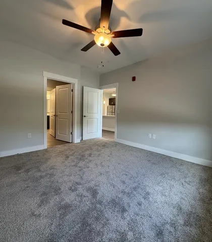 a view of a room with wooden floor