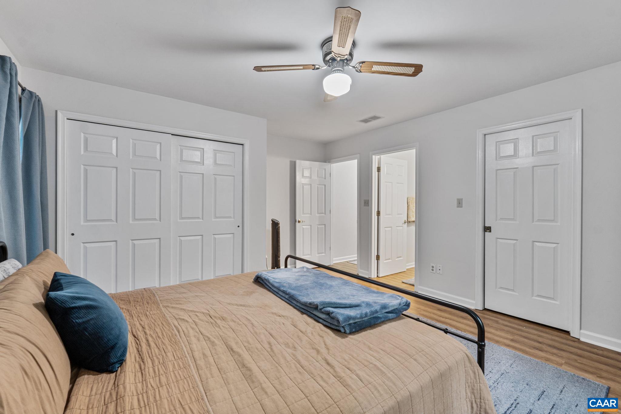 7 Sand Trap Terrace Palmyra, VA 22963 - Photo 19 of 27 a bedroom with a bed and a chandelier