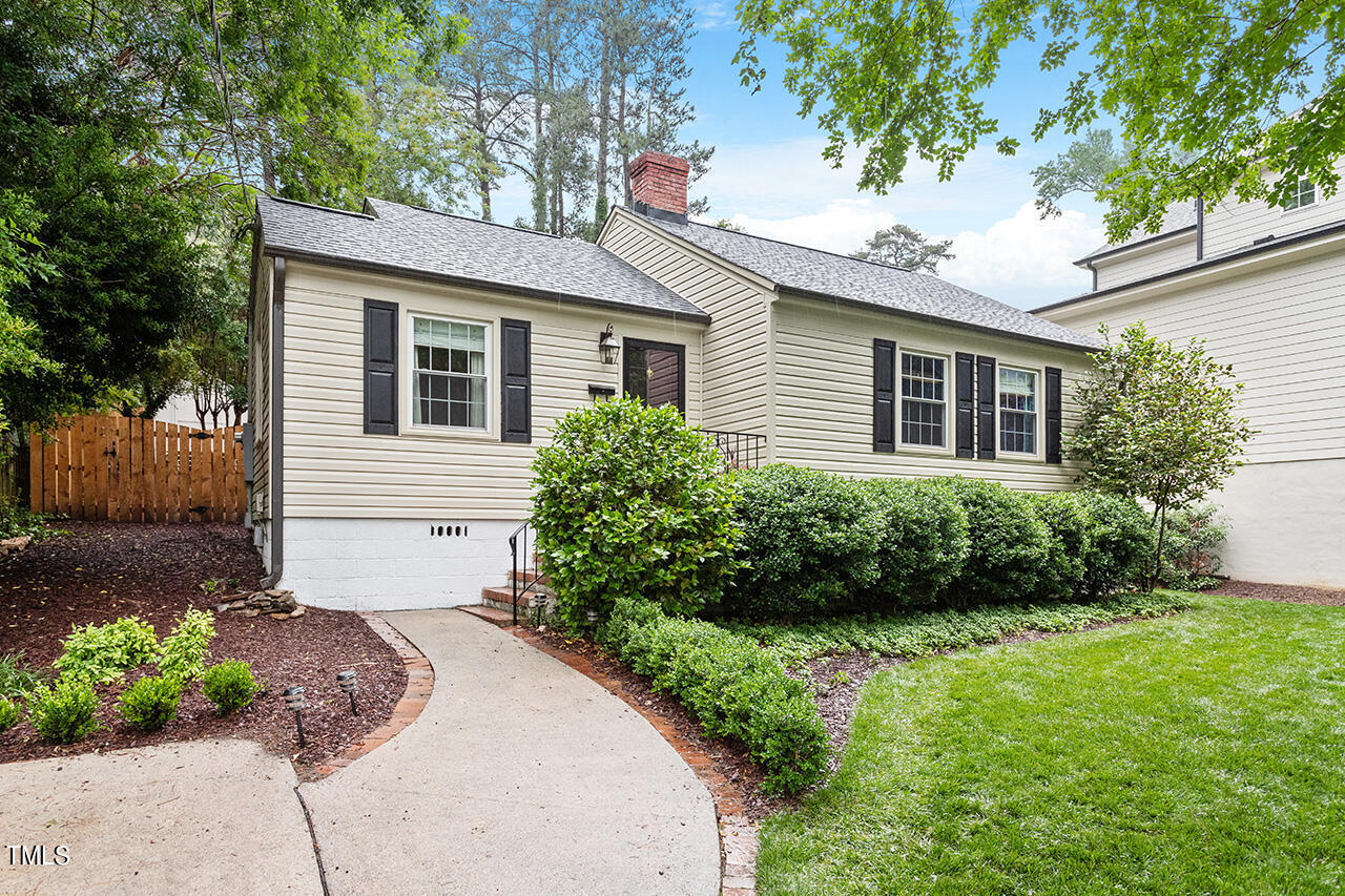 2718 Ashland Street Raleigh, NC 27608 - Photo 1 of 25 a front view of a house with a yard