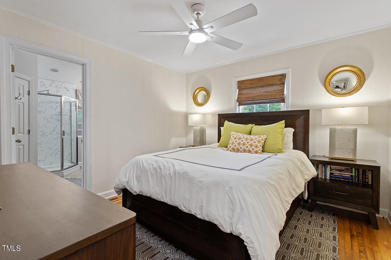 2718 Ashland Street Raleigh, NC 27608 - Photo 13 of 25 a bedroom with a bed and a lamp