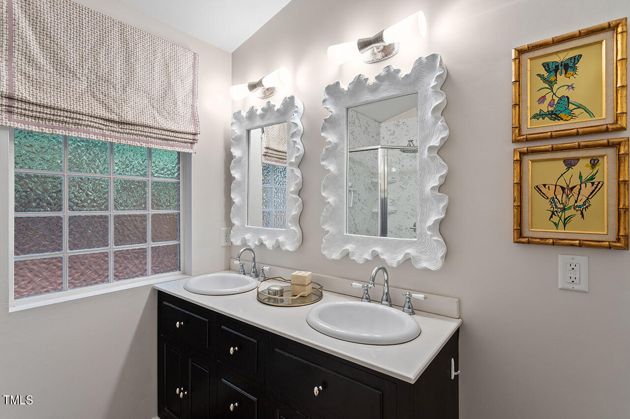 2718 Ashland Street Raleigh, NC 27608 - Photo 15 of 25 a bathroom with a double vanity sink mirror and double