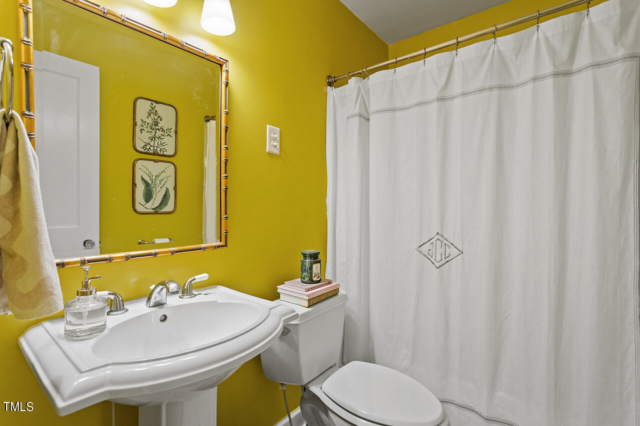 2718 Ashland Street Raleigh, NC 27608 - Photo 17 of 25 a bathroom with a sink and a mirror
