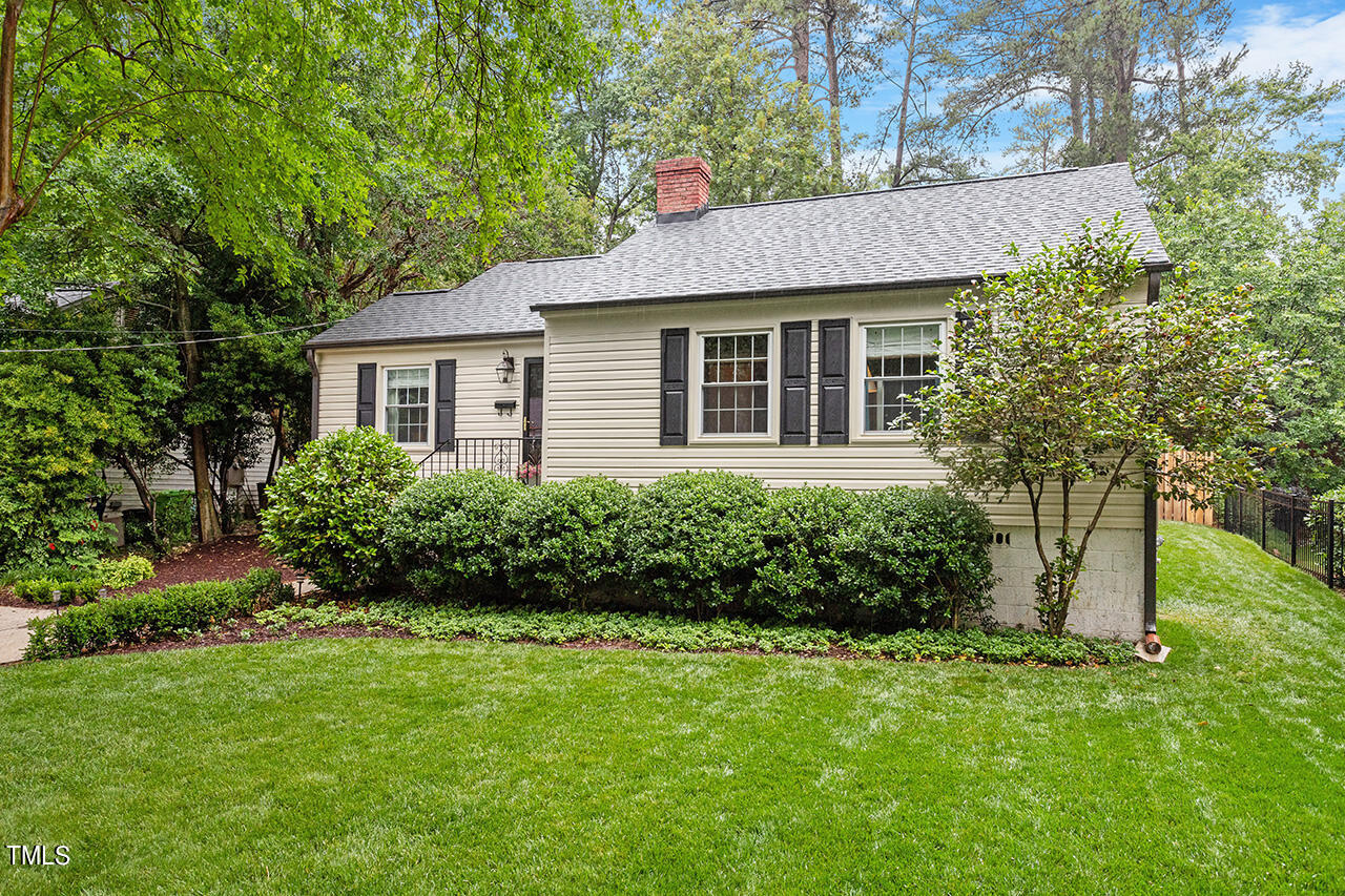 2718 Ashland Street Raleigh, NC 27608 - Photo 2 of 25 a view of a house with garden and yard