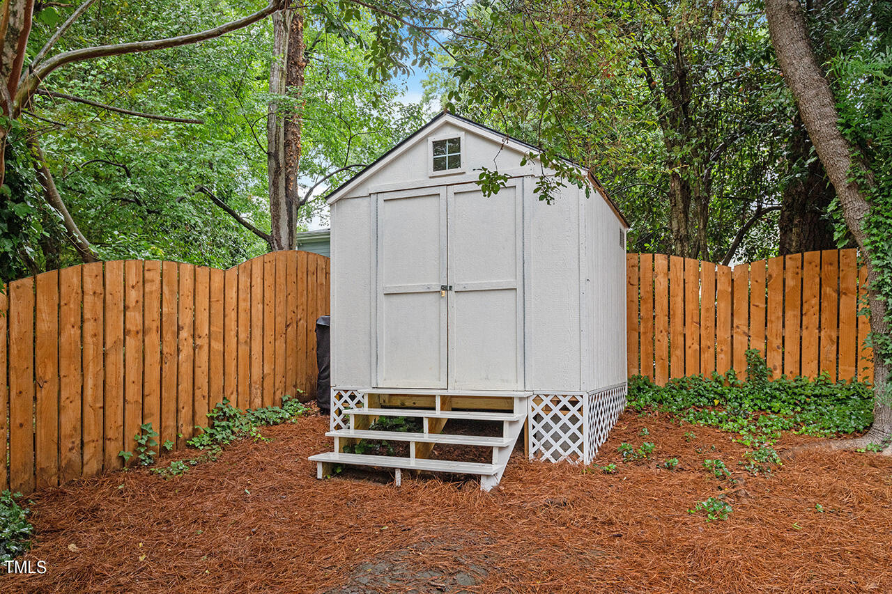 2718 Ashland Street Raleigh, NC 27608 - Photo 24 of 25 a front view of a house with a garden