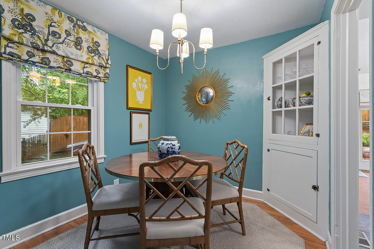 2718 Ashland Street Raleigh, NC 27608 - Photo 6 of 25 a view of a dining room with furniture and chandelier
