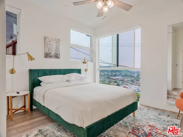 a bedroom with a bed and a chandelier