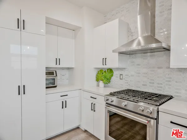 a stove top oven sitting inside of a kitchen