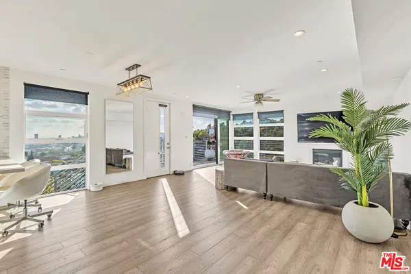 a living room with furniture windows and wooden floor