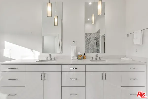 a bathroom with a double vanity sink and mirror