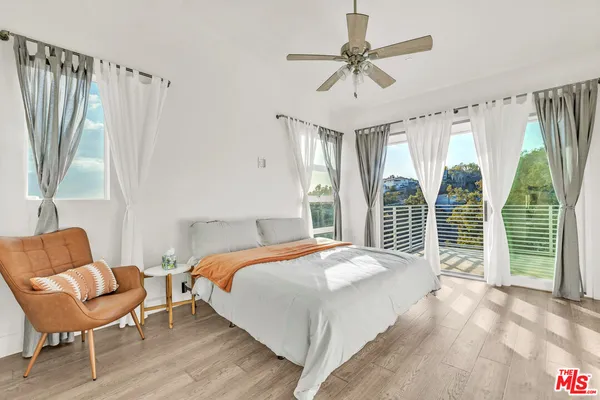 a bedroom with a bed and a chair