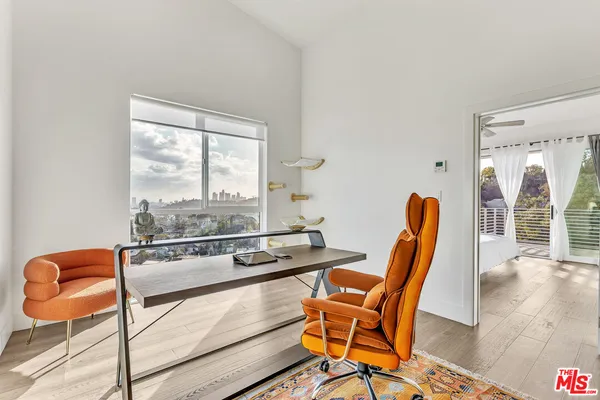 a dining room with furniture and wooden floor