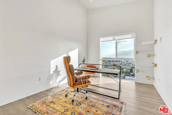a workspace with wooden floor and a rug