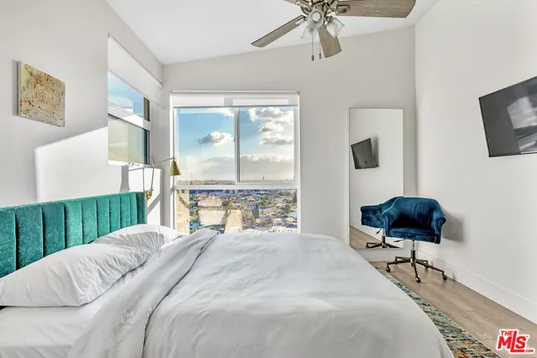 a bedroom with a large bed and a chandelier