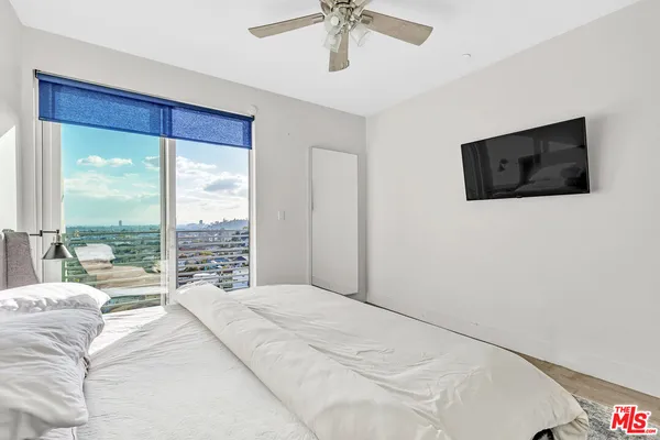 a bedroom with a large bed and a large window