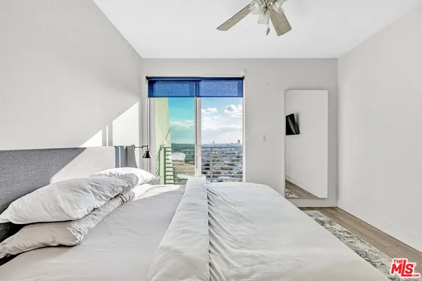a bedroom with a large bed and a chandelier
