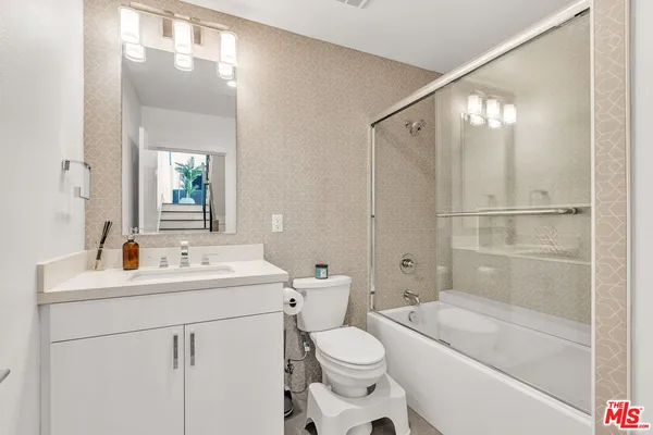 a view of a chairs and table in a balcony