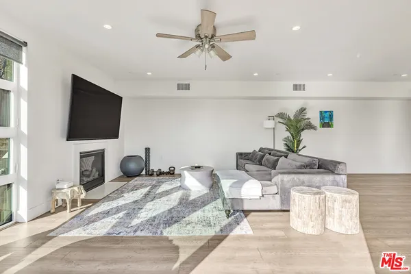 a view of a livingroom with furniture and a flat screen tv