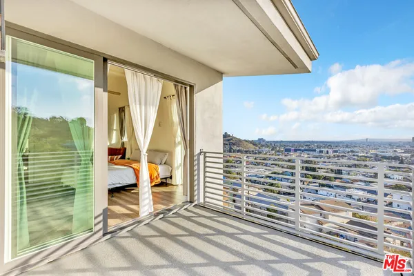 a view of a balcony with table and chairs