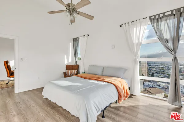 a bedroom with a bed and a window