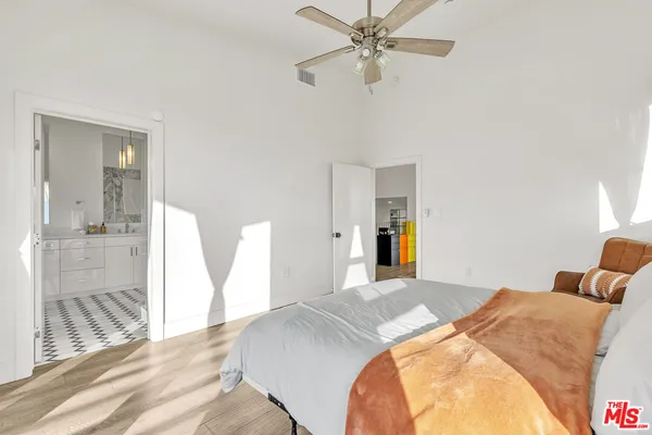 a bedroom with a bed and a chandelier