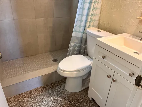 a bathroom with a toilet and a shower