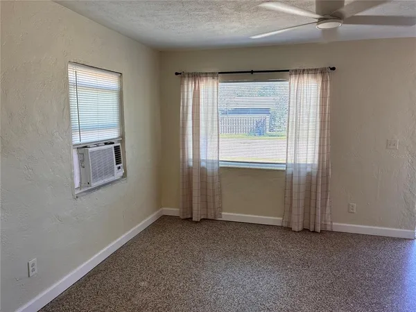 an empty room with windows and closet