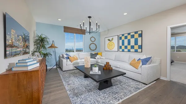 a living room with fireplace furniture and a chandelier