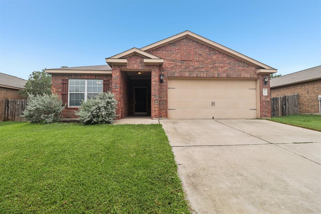 12629 Forest Lawn Road Rhome, TX 76078 - Photo 1 of 1 Ranch-style home with brick siding, driveway, and an attached garage