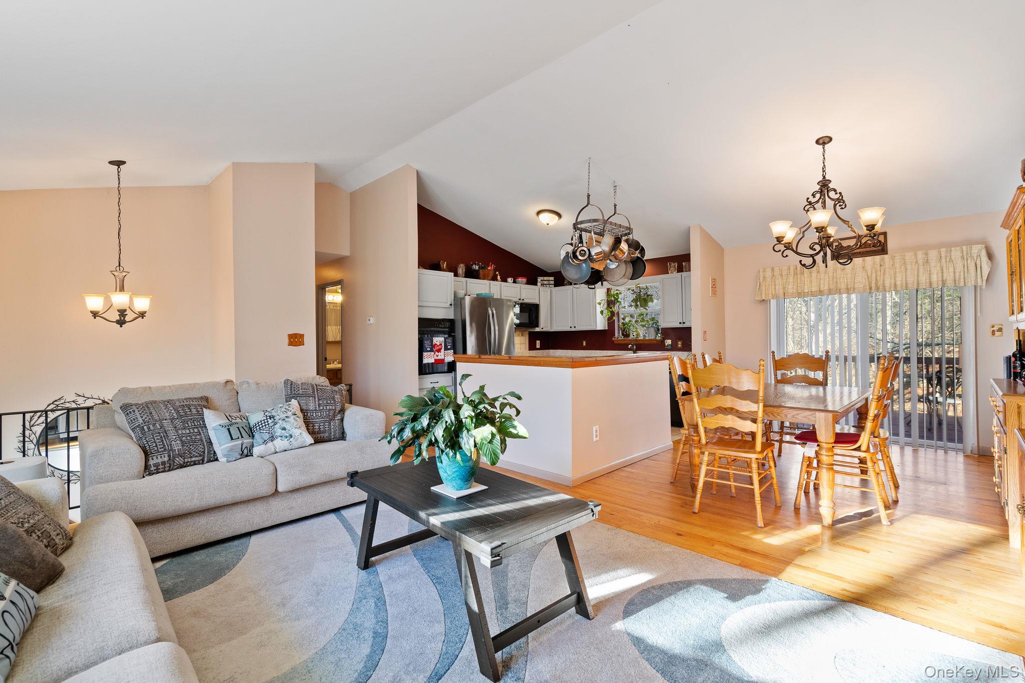 171 E Road Wallkill, NY 12589 - Photo 11 of 47 Living area with a chandelier, light wood-style flooring, and high vaulted ceiling