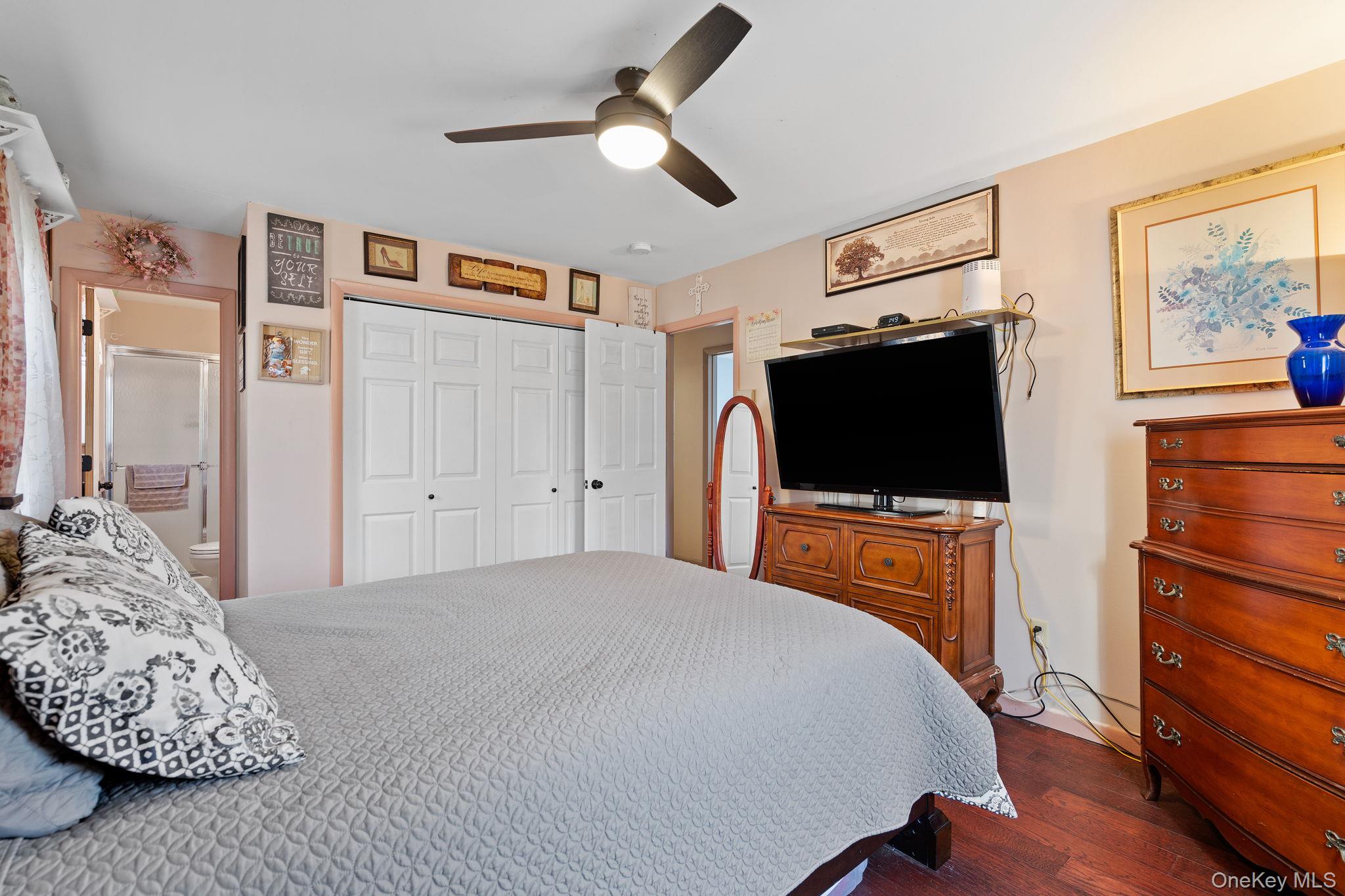 171 E Road Wallkill, NY 12589 - Photo 14 of 47 Bedroom featuring dark wood-style flooring, a closet, and a ceiling fan