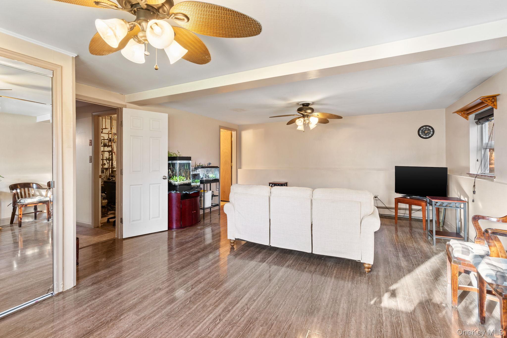 171 E Road Wallkill, NY 12589 - Photo 24 of 47 Living room featuring wood finished floors and a ceiling fan