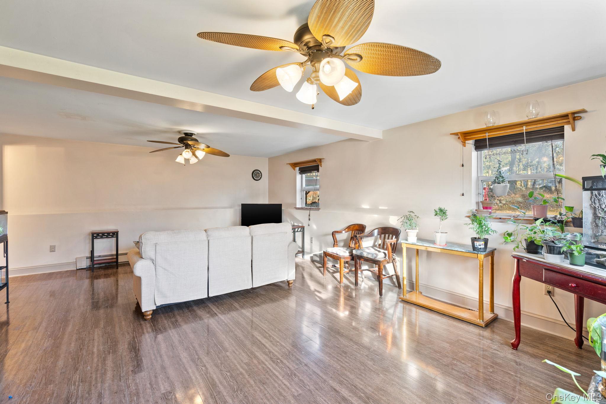 171 E Road Wallkill, NY 12589 - Photo 25 of 47 Living area featuring a ceiling fan, wood finished floors, and beamed ceiling
