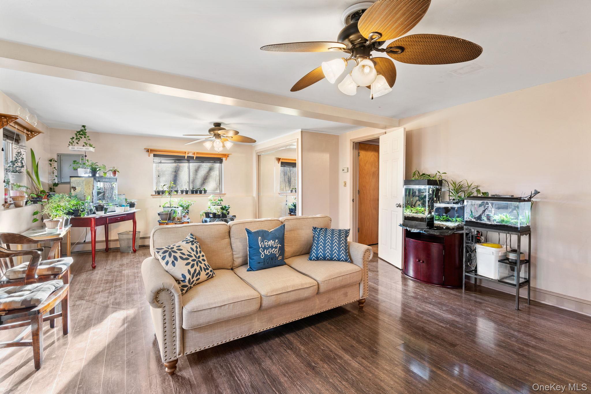 171 E Road Wallkill, NY 12589 - Photo 26 of 47 Living room with wood finished floors, a ceiling fan, and a baseboard heating unit
