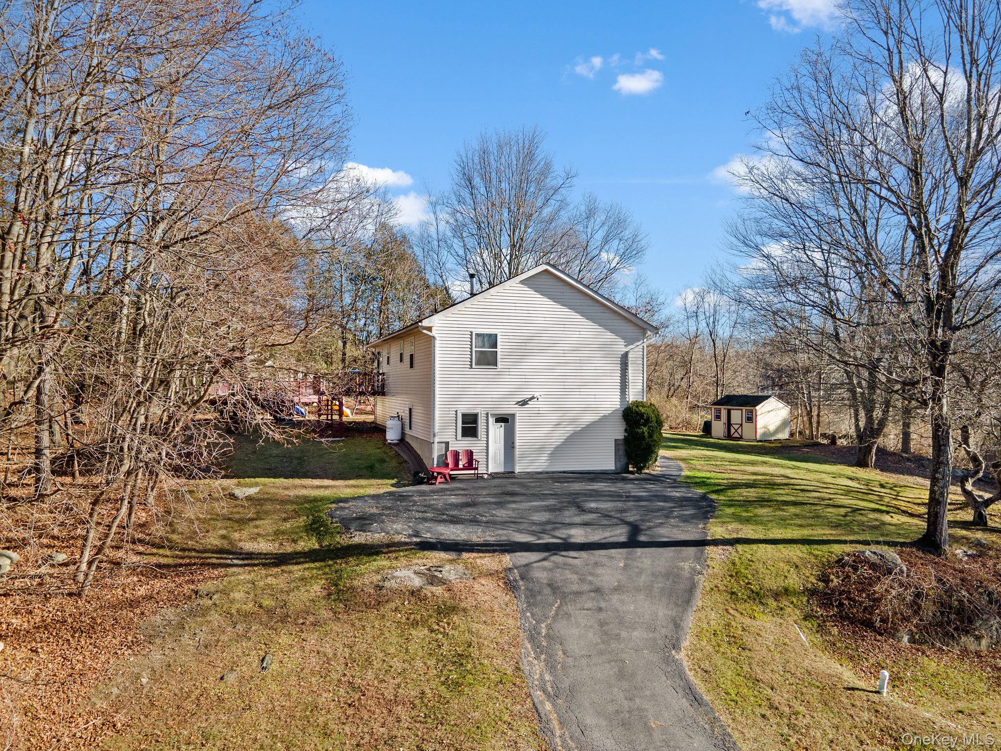 171 E Road Wallkill, NY 12589 - Photo 34 of 47 View of home's exterior featuring asphalt driveway and a lawn