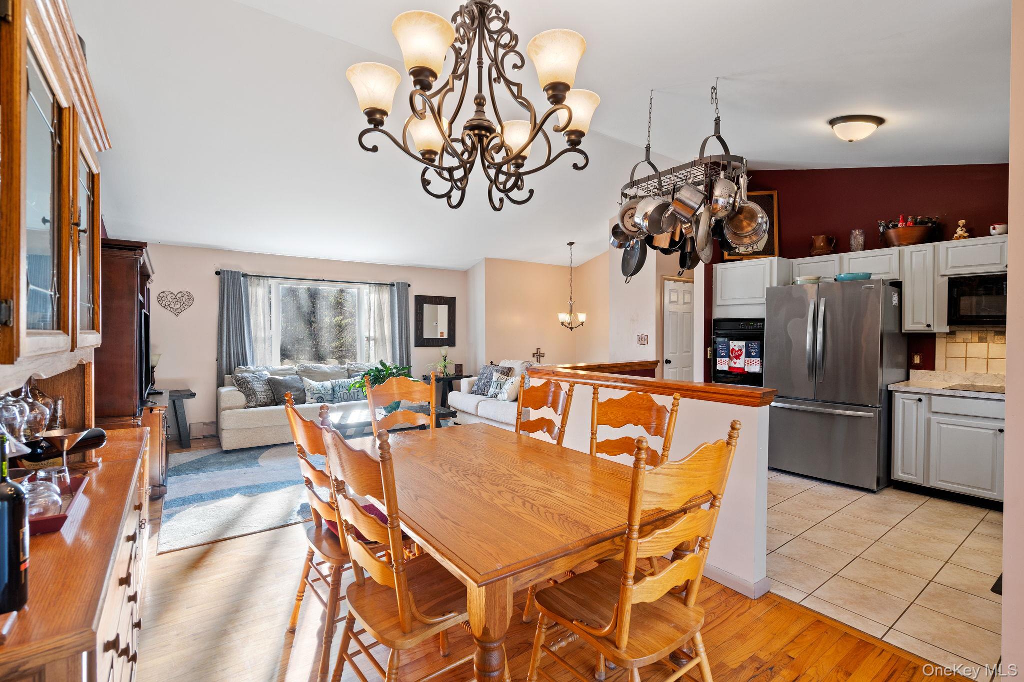171 E Road Wallkill, NY 12589 - Photo 7 of 47 Dining space featuring a chandelier, light wood finished floors, and lofted ceiling