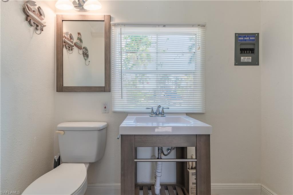 5216 Pineland Daisy Trail Fort Myers, FL 33905 - Photo 16 of 16 Half bath with toilet and a textured wall