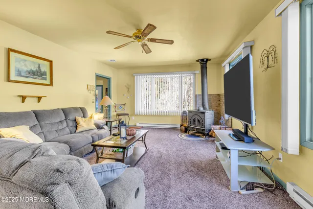 a view of a dining room with furniture a chandelier and wooden floor