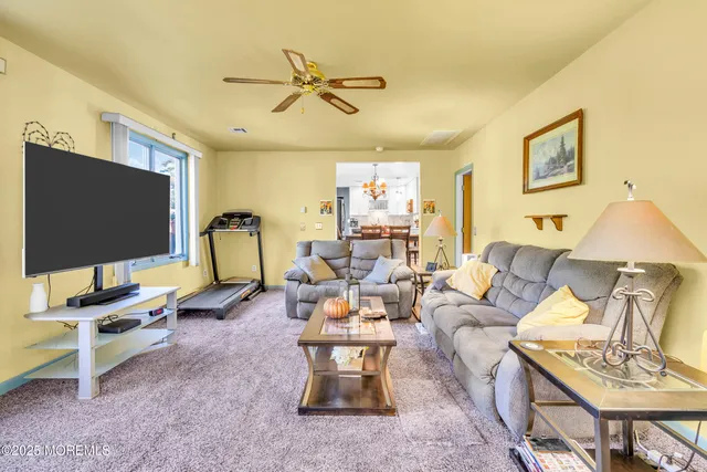 a dining room filled chandelier and wooden floor