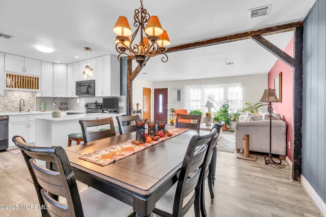 a kitchen with stainless steel appliances kitchen island granite countertop a refrigerator and a sink