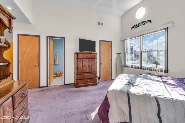 a bathroom with a granite countertop sink mirror vanity and toilet