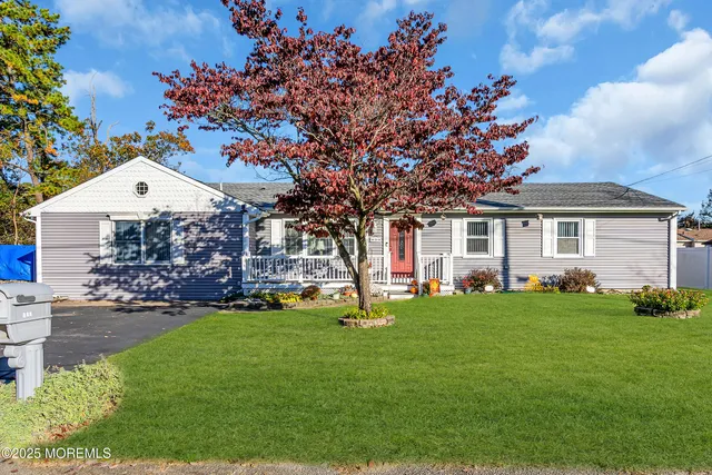 a front view of a house with a garden
