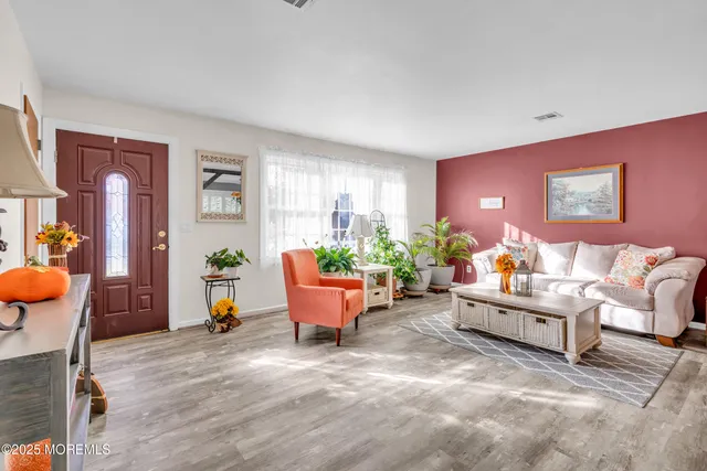 a view of a dining room with furniture and a chandelier