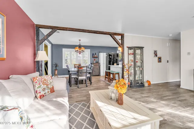 a living room with furniture a window and a flat screen tv