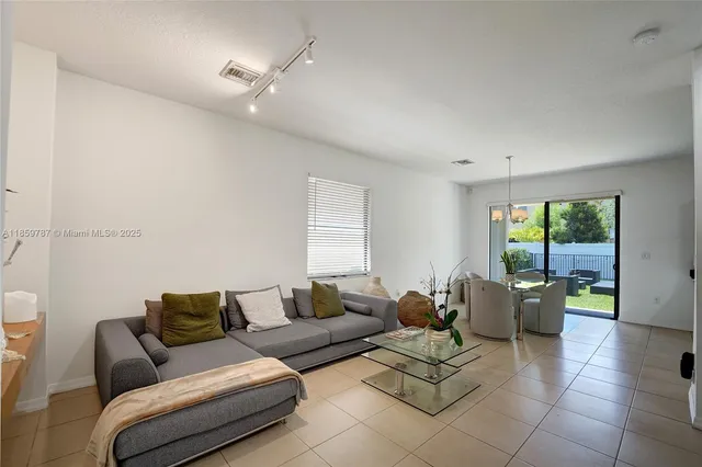 a living room with furniture a couch and a potted plant