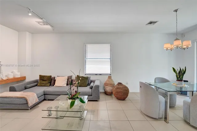 a kitchen with stainless steel appliances granite countertop a refrigerator sink and stove