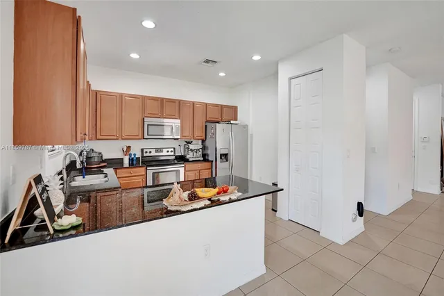 a bathroom with a double vanity sink mirror and shower